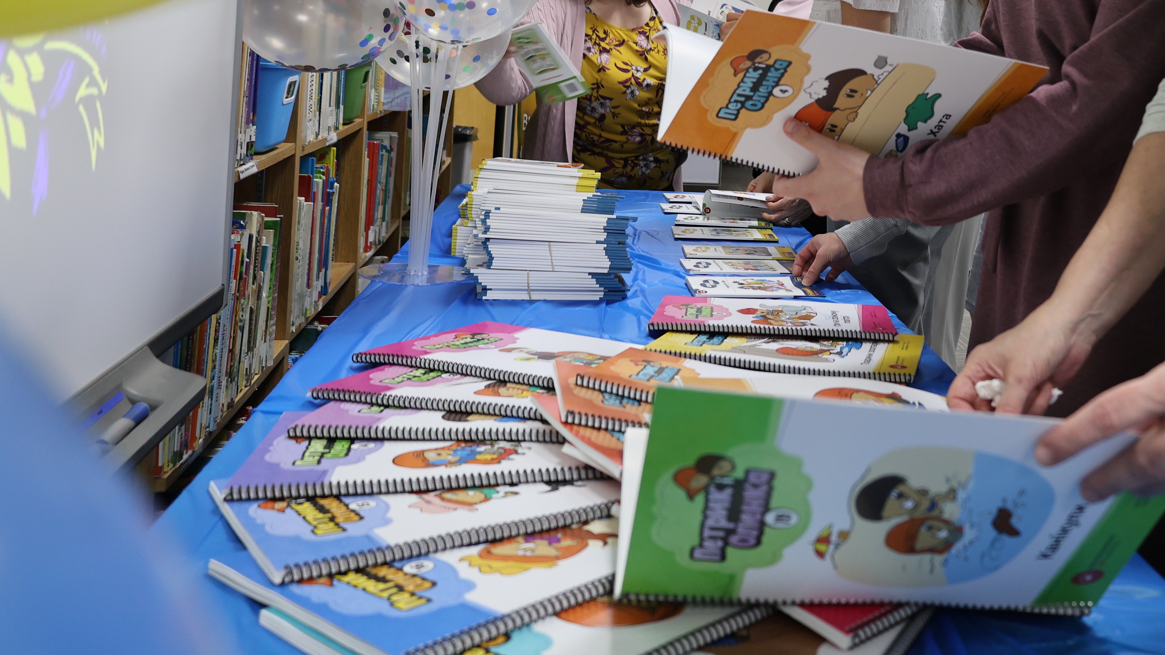 teachers explore a display of new Ukrainian learning materials