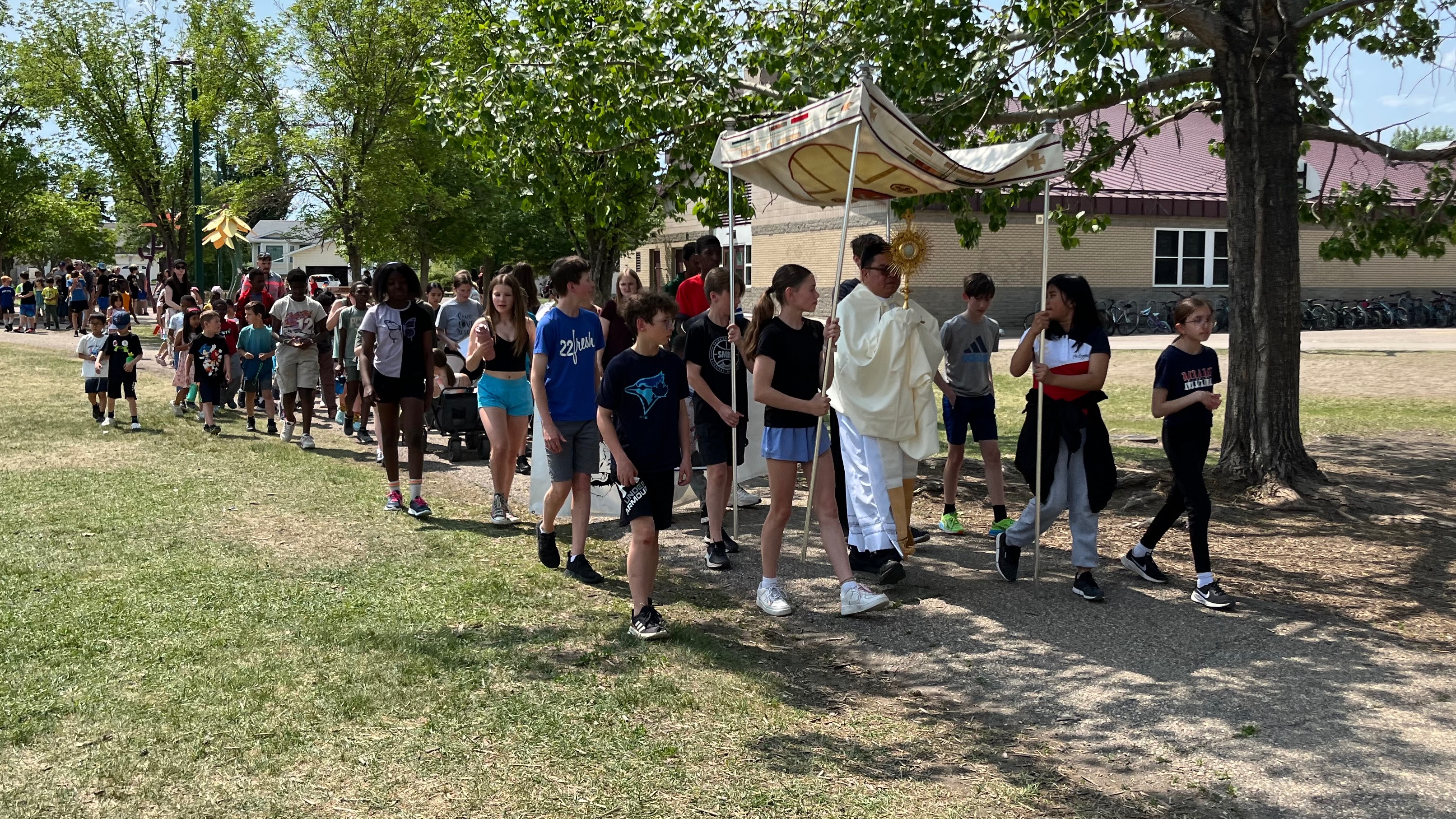 École St. Mother Teresa students walking in the Eucharistic procession